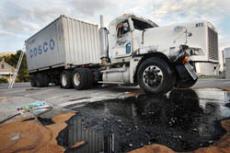 Semi rolls over spills oil, stalls traffic