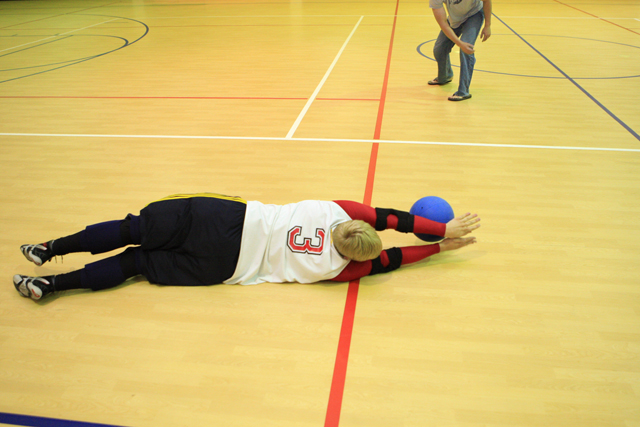 Balls fly at blindfolded students throughout the game of goalball