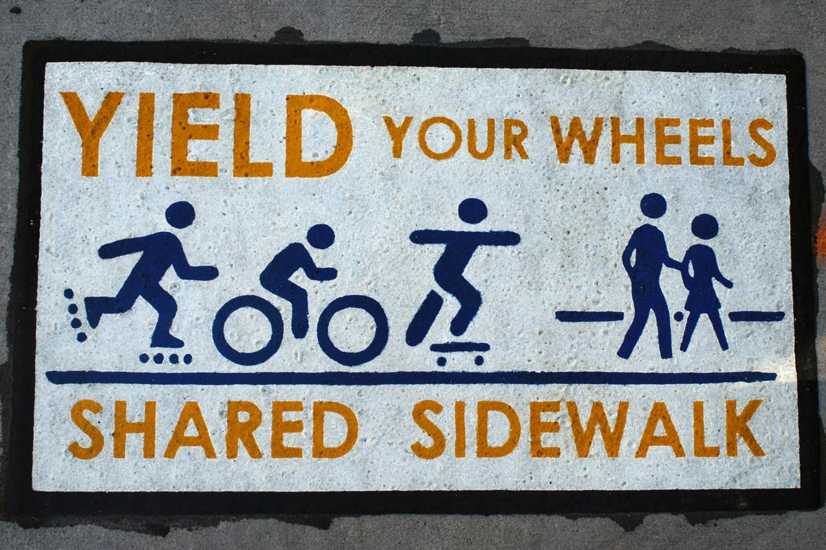Sidewalk signs regulate campus traffic