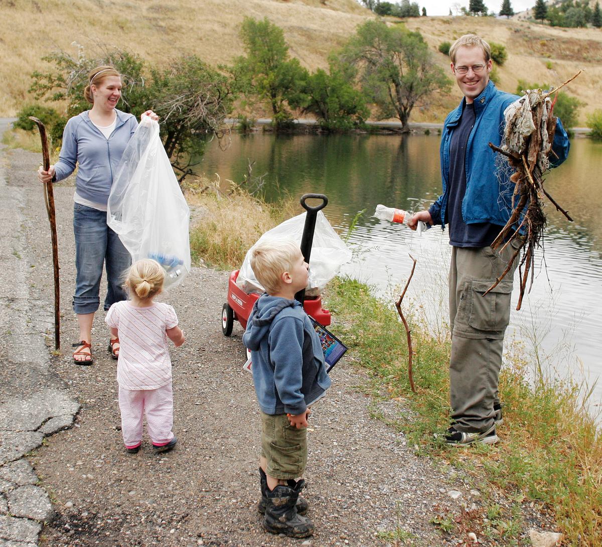 Community members gather to clean debris and buildup from First Dam