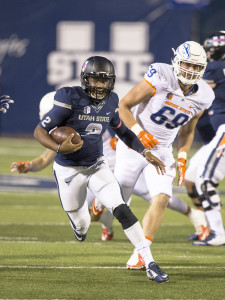 Oct 16, 2015; Logan, UT, USA; Utah State Aggies quarterback Kent Myers (2) carries the ball past Boise State Broncos defensive tackle Tyler Horn (69) in the first half at Romney Stadium. 