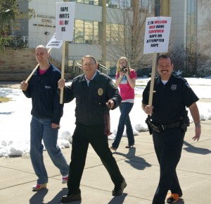 Ryan Barfuss, Chief Mecham and Officer Chad Vernon of the Logan City Police march against rape while wearing high heels at Walk a Mile in Her Shoes in 2011. Photo courtesy of Heather Strong.