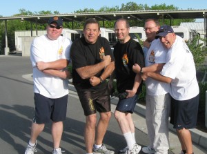 Fire Marshal Jason Winn, Captain Milne, Lieutenant Shane Sessions, Chief Mecham, Office Sutton Hanzalik demonstrate their strength before the 2009 Special Olympics torch run. Photo courtesy of Heather Strong.