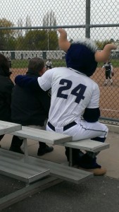 Chief Steven Mecham, who has always been a big fan of Utah State University sports, watches a softball game with USU's mascot, Big Blue. Photo courtesy of Heather Strong.