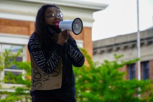 Kylie Jackson uses a megaphone to talk to protestors at a demonstration against police brutality.