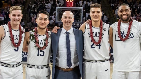 Head coach Craig Smith standing with players honored on Senior Night in February 2020. (left to right) Sam Merrill, Diogo Brito, Craig Smith, Abel Porter, and Roche Grootfaam.