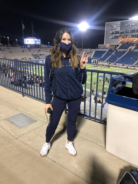 Spirit Squad Coach Morgan Watts poses at a USU football game.