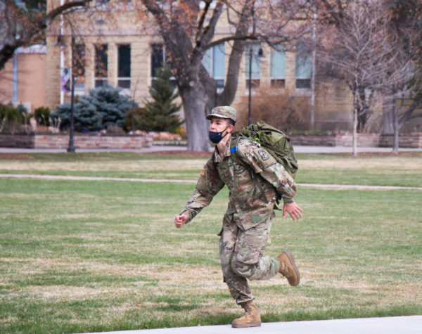 An ROTC cadet finishes their 1.3-mile run to reenact the the Battle of Marathon.