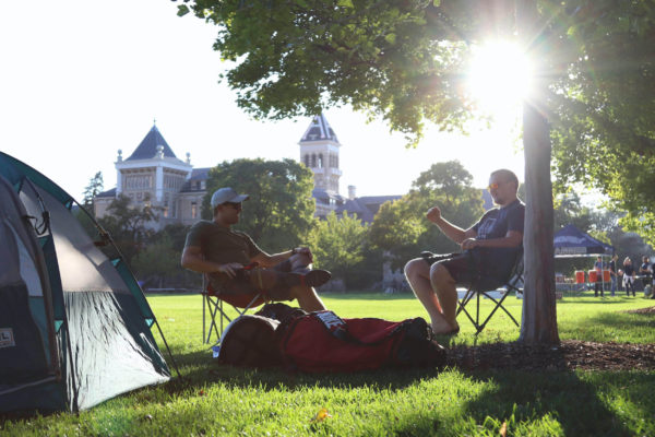 Andrew Watt and Easton Roos relax next to their tents on the Quad. 